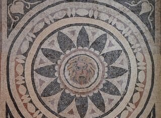 899px-4th_century_AD_Mosaic_with_mask_of_Phobos_(Fear)_within_a_radiating_petal_design,_from_Halicanassus_(Asia_Minor),_British_Museum_(14256569991)